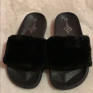Black furry slippers